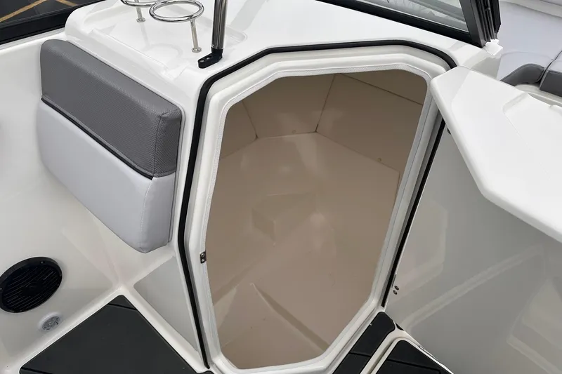 Slide: The Image of 2026 Bayliner D22 boat interior with open storage compartment and cushioned seating. - 30