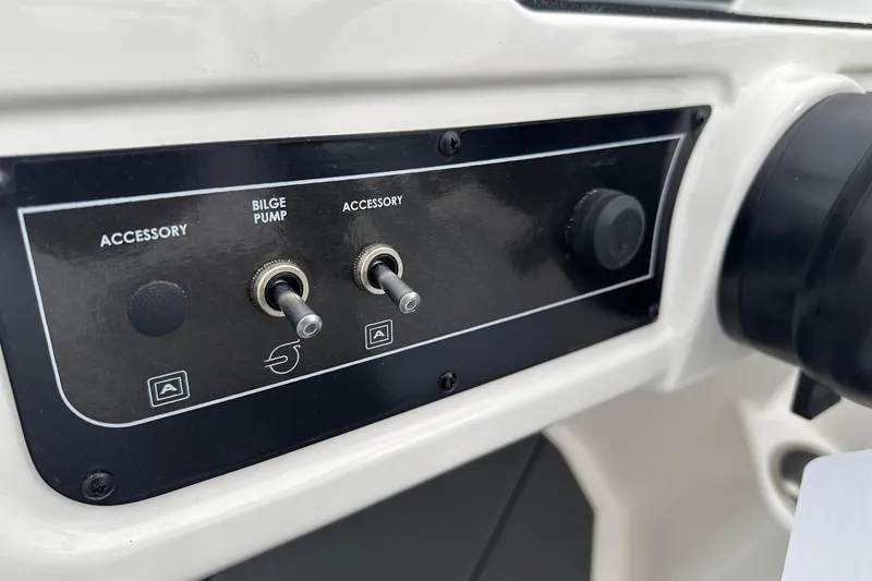 Slide: The Image of Control panel of 2026 Bayliner D22 boat with accessory and bilge pump switches. - 33