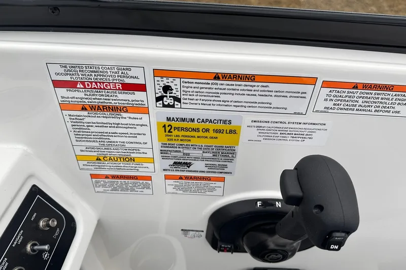Slide: The Image of 2026 Bayliner D22 boat safety and capacity labels, including warnings and maximum capacity details. - 35