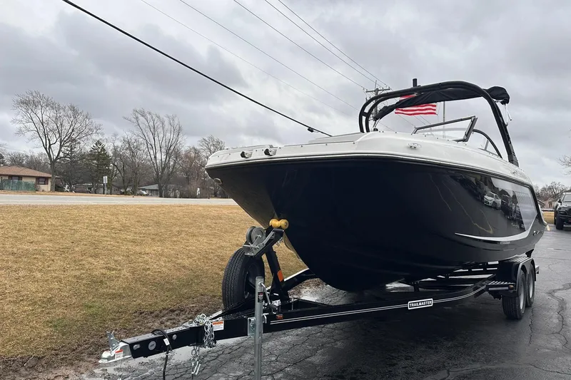 Slide: The Image of 2026 Bayliner D22 boat on trailer, parked outdoors under cloudy sky. - 43