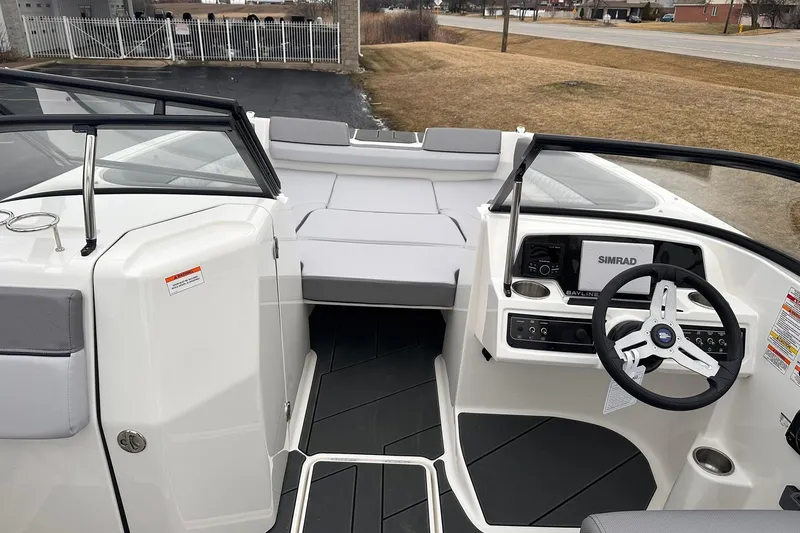 Slide: The Image of 2026 Bayliner D22 boat interior with steering wheel and dashboard, featuring Simrad electronics. - 9