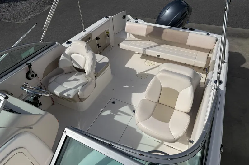 Slide: The Image of 2026 Robalo R277 Dual Console boat interior with seating and steering wheel. - 13