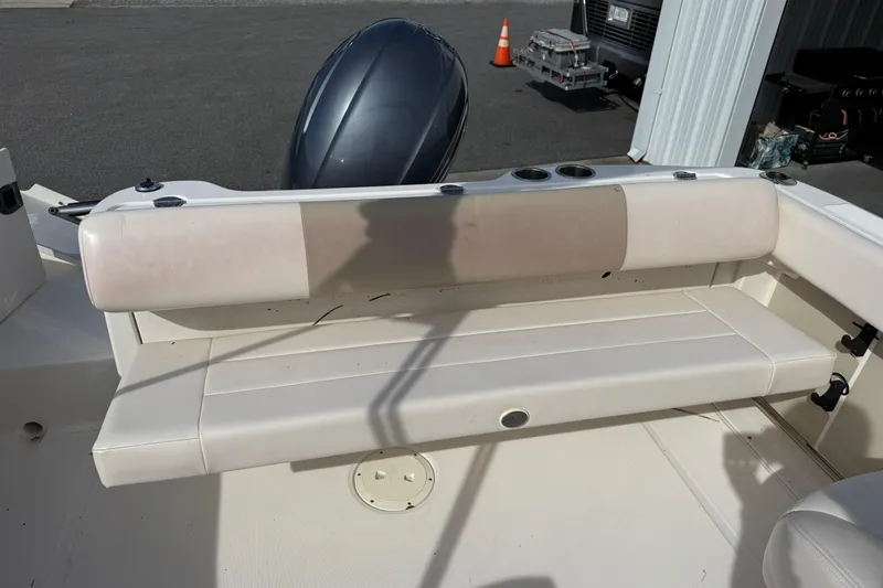 Slide: The Image of 2026 Robalo R277 Dual Console boat with cushioned seating and cup holders. - 16