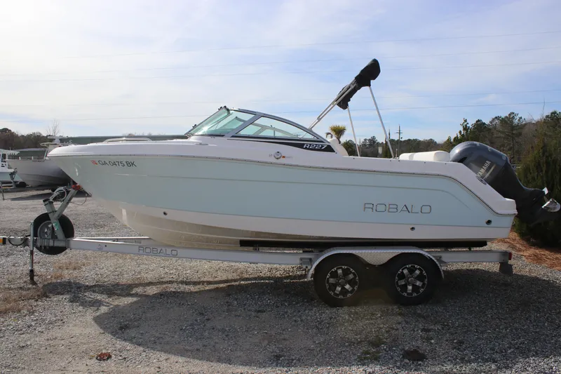 Slide: The Image of 2026 Robalo R277 Dual Console boat on trailer, side view. - 4