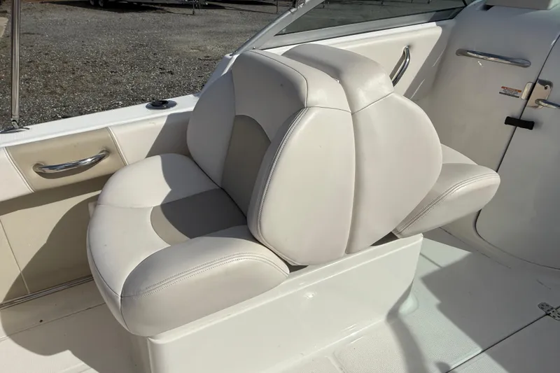 Slide: The Image of 2026 Robalo R277 Dual Console boat seat, white leather, sleek design. - 9