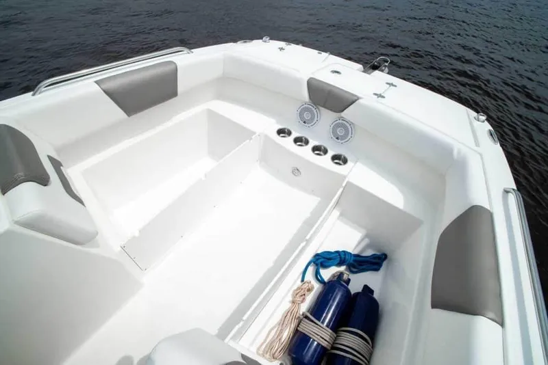 Slide: The Image of Manufacturer Provided Image: 2026 World Cat 230 SD boat interior with seating, cup holders, and nautical equipment on water. - 11