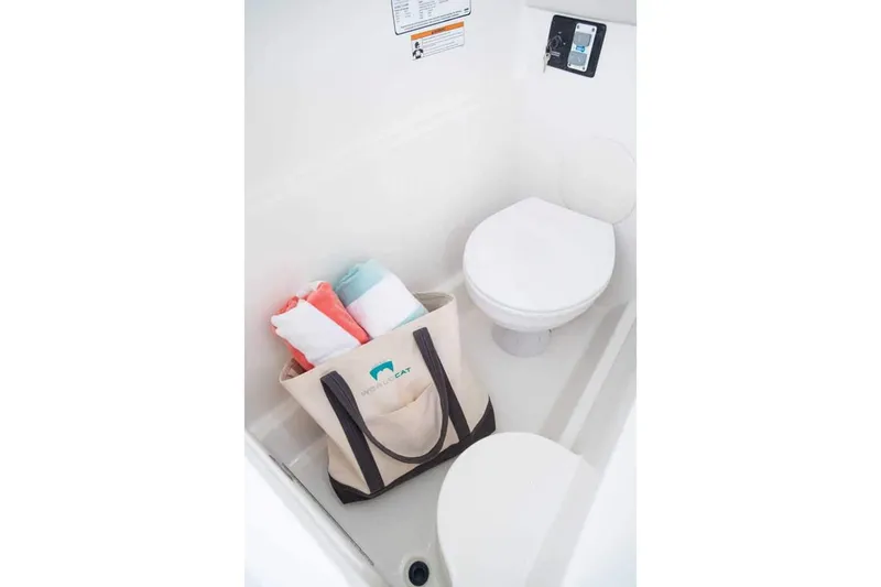 Slide: The Image of Manufacturer Provided Image: Interior of 2026 World Cat 230 SD boat bathroom with tote bag and towels. - 20