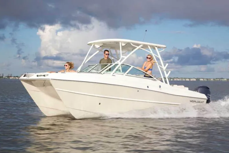 Slide: The Image of Manufacturer Provided Image: 2026 World Cat 230 SD boat cruising on open water with three passengers. - 3