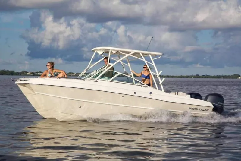 Slide: The Image of Manufacturer Provided Image: 2026 World Cat 230 SD boat cruising on water with three passengers under cloudy sky. - 5