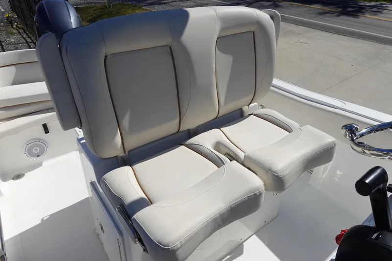 Slide: The Image of 2022 Sea Hunt Ultra 234 boat with comfortable dual seating and steering wheel. - 17