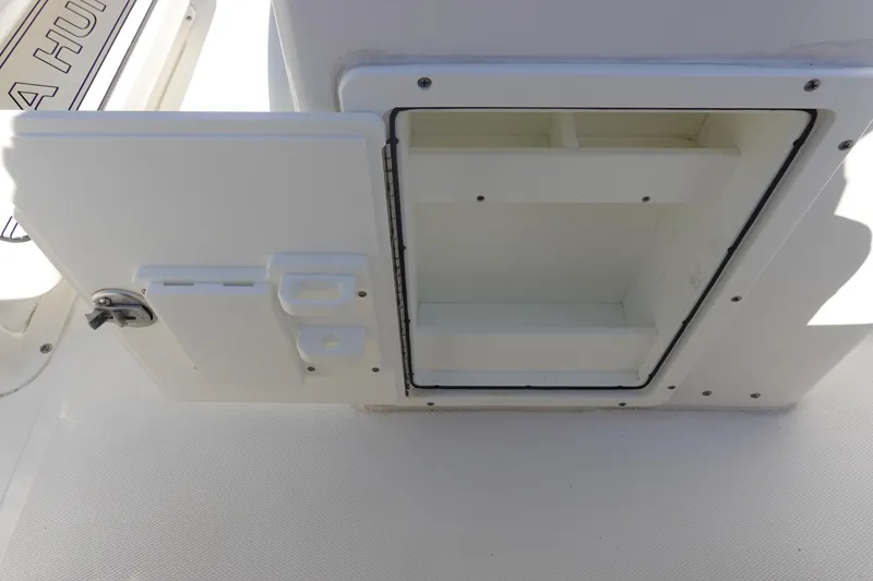 Slide: The Image of Open storage compartment on 2022 Sea Hunt Ultra 234 boat. - 19
