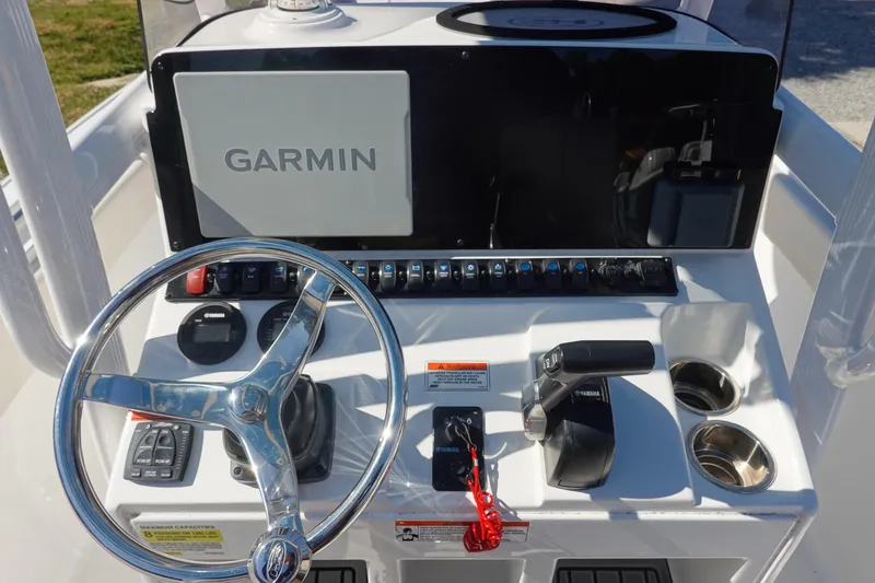 Slide: The Image of 2022 Sea Hunt Ultra 234 boat dashboard with Garmin display and steering wheel. - 21