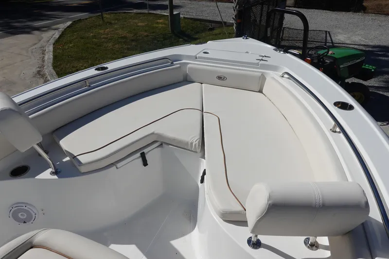 Slide: The Image of 2022 Sea Hunt Ultra 234 boat interior with white cushioned seating. - 27