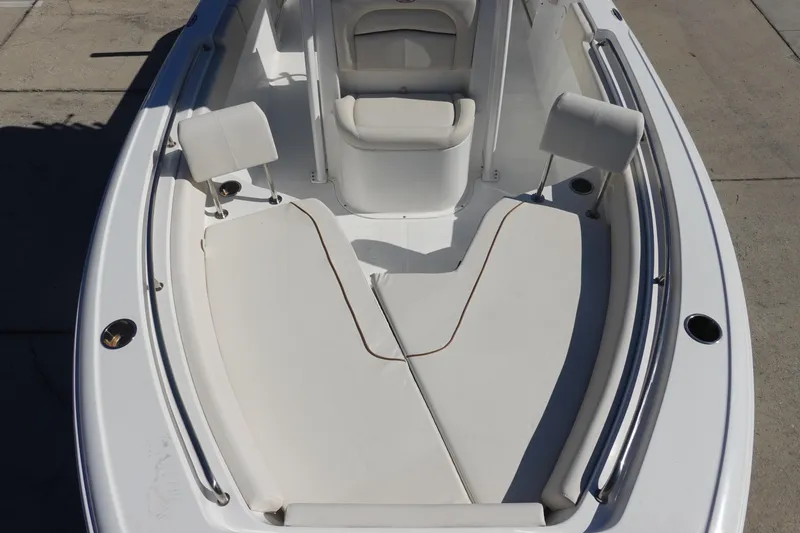 Slide: The Image of 2022 Sea Hunt Ultra 234 boat interior with cushioned seating and stainless steel railings. - 28