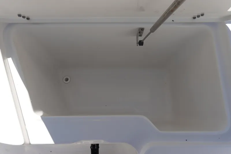 Slide: The Image of 2022 Sea Hunt Ultra 234 boat storage compartment, open and empty. - 31