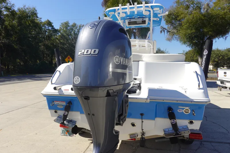 Slide: The Image of 2022 Sea Hunt Ultra 234 boat with Yamaha 200 engine, parked outdoors. - 5