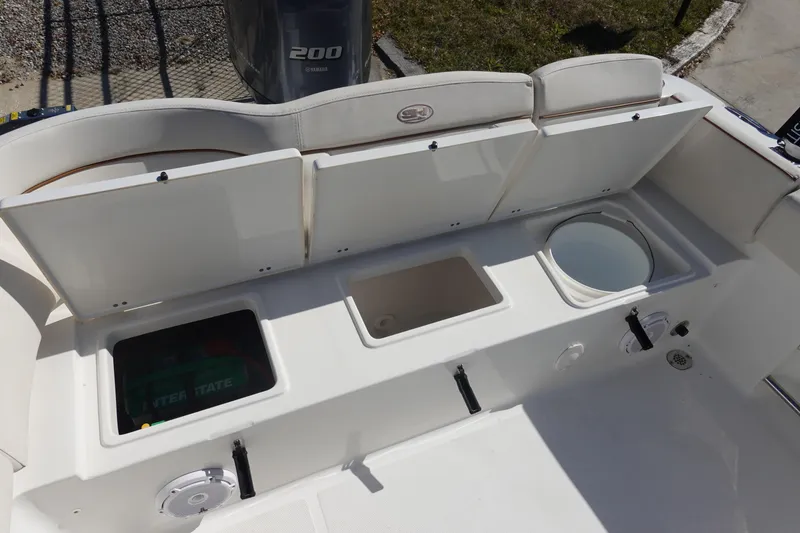 Slide: The Image of 2022 Sea Hunt Ultra 234 boat storage compartments and seating area. - 8