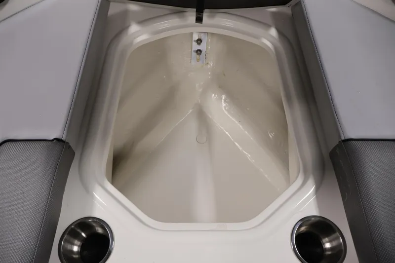 Slide: The Image of 2026 Bayliner VR6 Bowrider I/O interior storage compartment with cup holders. - 11