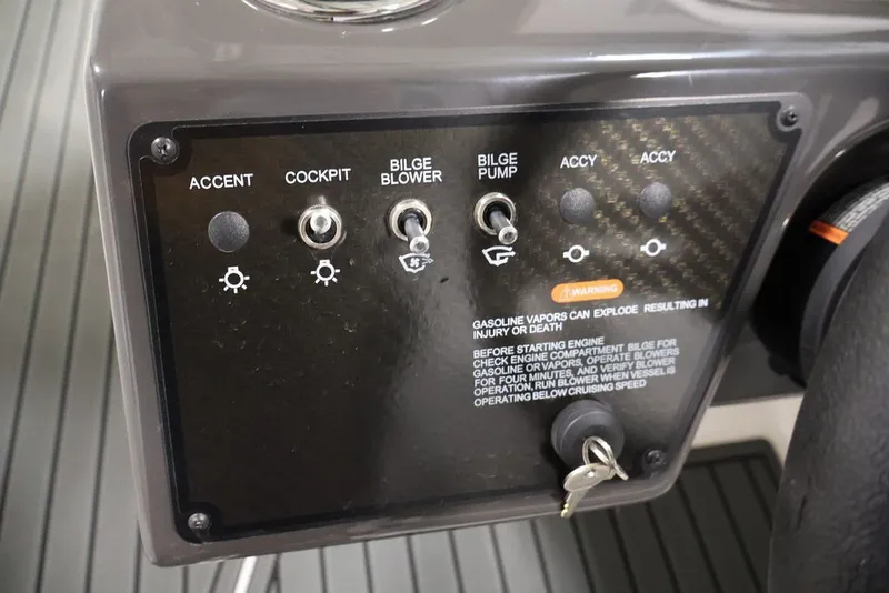 Slide: The Image of Control panel of 2026 Bayliner VR6 Bowrider I/O with switches and safety warning. - 26