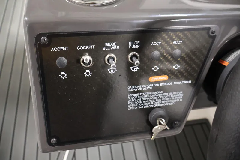 Slide: The Image of Control panel of 2026 Bayliner VR6 Bowrider I/O with switches and warning label. - 19