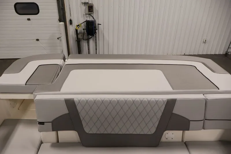 Slide: The Image of 2026 Bayliner VR6 Bowrider I/O interior with sleek, modern seating design in a garage setting. - 36