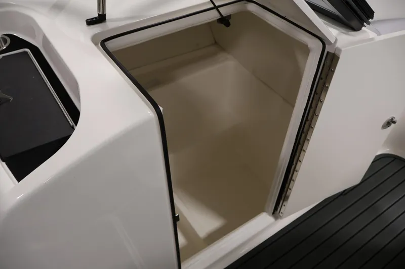 Slide: The Image of 2026 Bayliner VR6 Bowrider I/O storage compartment with open hatch and sleek design. - 26