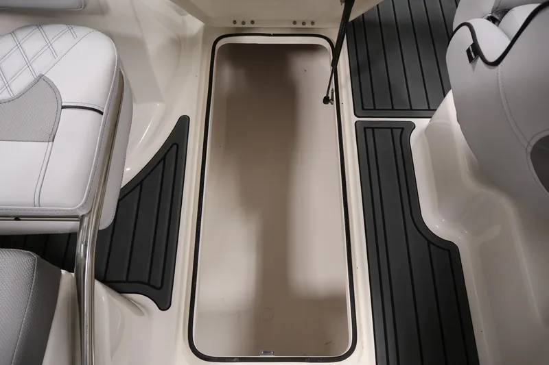Slide: The Image of 2026 Bayliner VR6 Bowrider I/O interior with storage compartment and cushioned seating. - 30