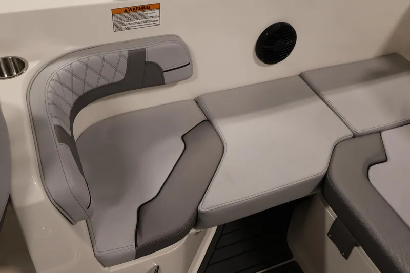 Slide: The Image of 2026 Bayliner VR6 Bowrider I/O interior seating with gray upholstery and speaker. - 32