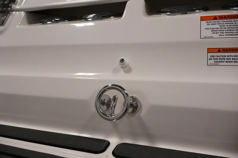 Slide: The Image of 2026 Bayliner VR6 Bowrider I/O boat stern with warning labels and chrome fittings. - 34