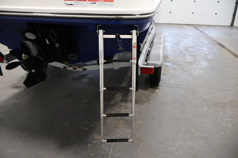 Slide: The Image of 2026 Bayliner VR6 Bowrider I/O with ladder and propeller in a garage setting. - 35