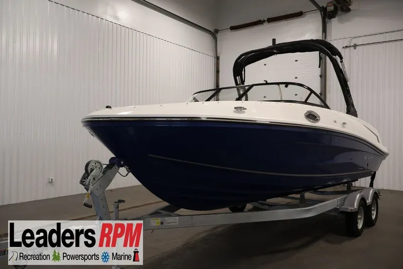 The Image of 2026 Bayliner VR6 Bowrider I/O in showroom, blue hull, on trailer. - 1