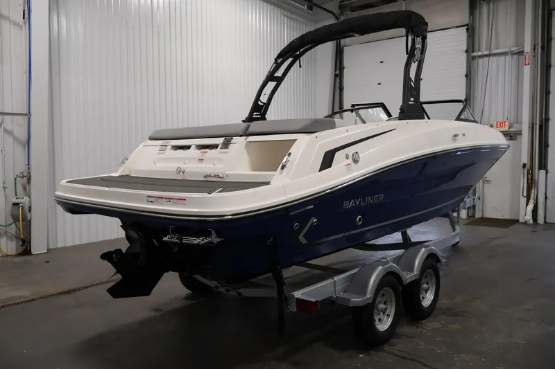 Slide: The Image of 2026 Bayliner VR6 Bowrider I/O boat on trailer in indoor storage facility. - 4