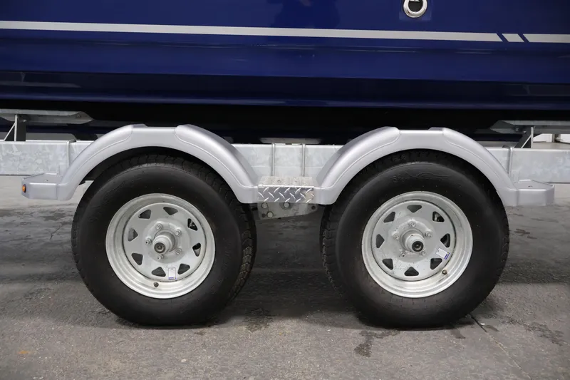 Slide: The Image of 2026 Bayliner VR6 Bowrider I/O trailer wheels on a concrete surface. - 40