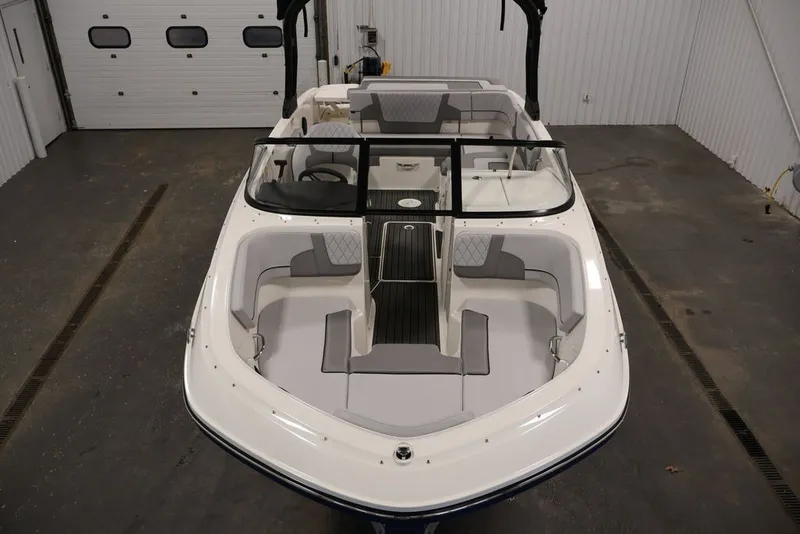 Slide: The Image of 2026 Bayliner VR6 Bowrider I/O in a garage, showcasing sleek design and spacious seating. - 14