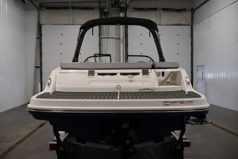 Slide: The Image of 2026 Bayliner VR6 Bowrider I/O in a garage, rear view. - 5
