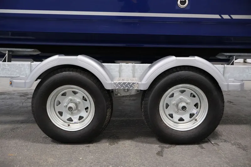 Slide: The Image of Trailer wheels of a 2026 Bayliner VR6 Bowrider I/O boat, parked indoors. - 45