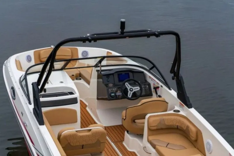Slide: The Image of 2026 Bayliner VR6 Bowrider I/O with tan seating and sleek design on water. - 35