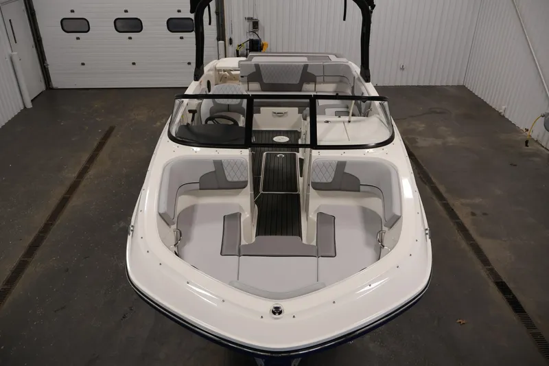Slide: The Image of 2026 Bayliner VR6 Bowrider I/O in a garage, showcasing sleek design and spacious seating. - 8