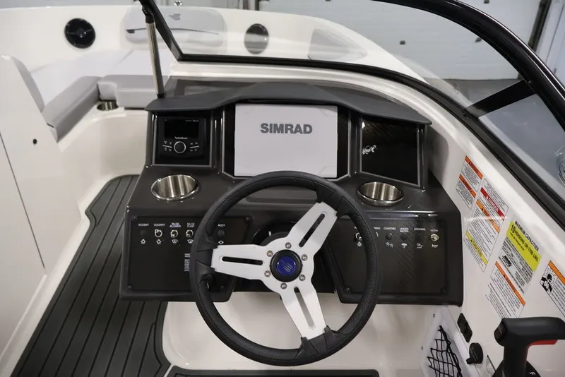Slide: The Image of 2026 Bayliner VR6 Bowrider I/O dashboard with steering wheel and Simrad display. - 16