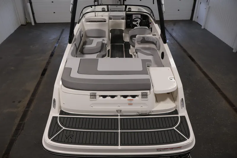 Slide: The Image of 2026 Bayliner VR6 Bowrider I/O with spacious seating and sleek design in a showroom. - 9