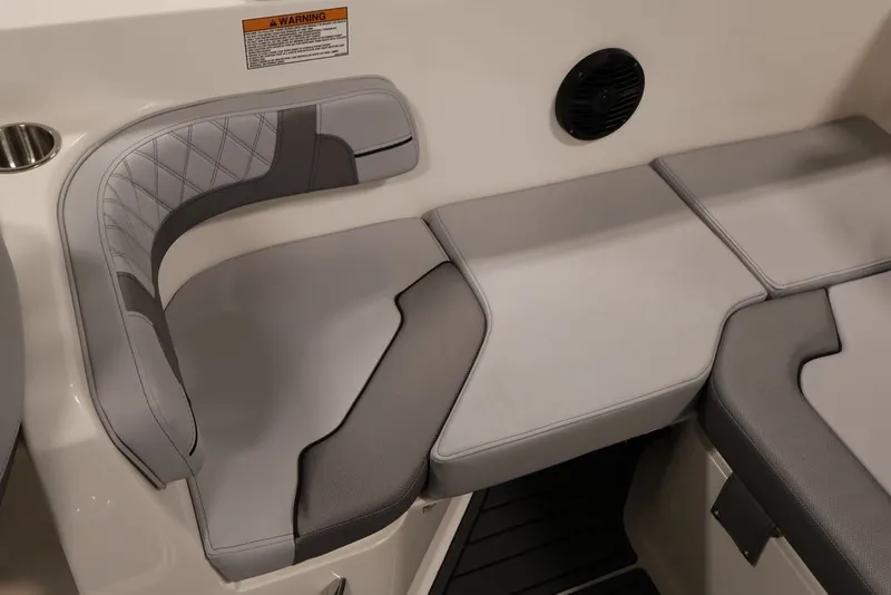 Slide: The Image of 2026 Bayliner VR6 Bowrider I/O interior seating with gray upholstery and speaker. - 37