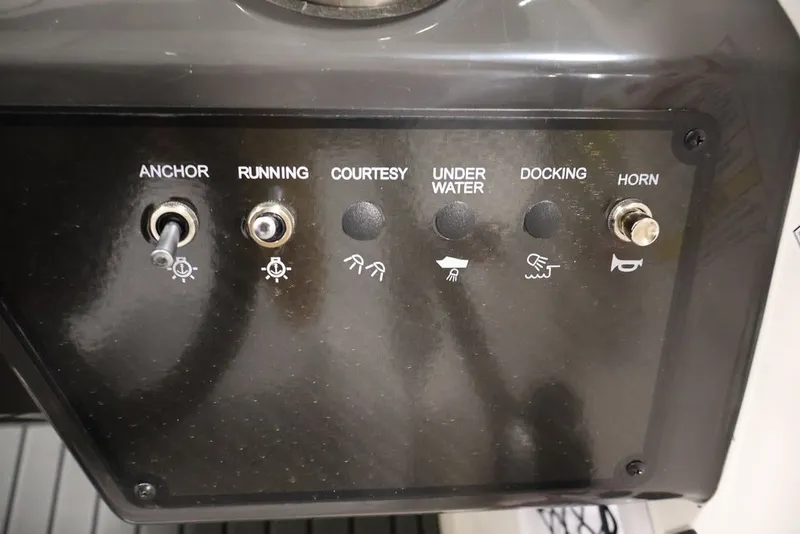 Slide: The Image of Control panel of 2026 Bayliner VR6 Bowrider I/O with switches for anchor, running, and horn. - 18