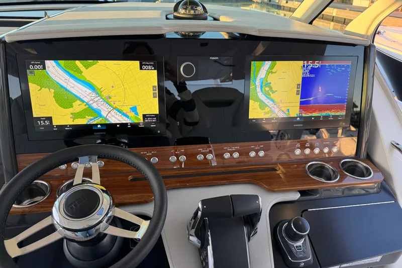 Slide: The Image of Helm of 2025 Tiara Yachts 38 LS with dual navigation screens and controls. - 10