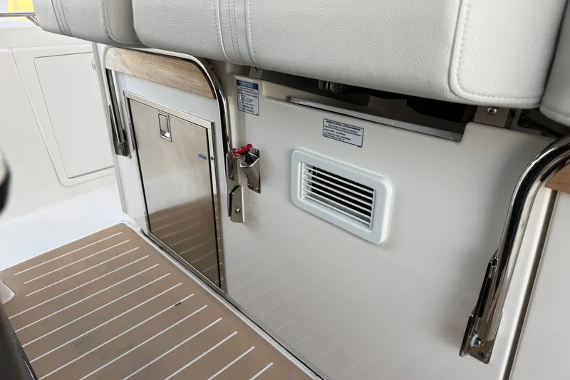 Slide: The Image of Interior view of 2025 Tiara Yachts 38 LS, featuring sleek seating and storage. - 13