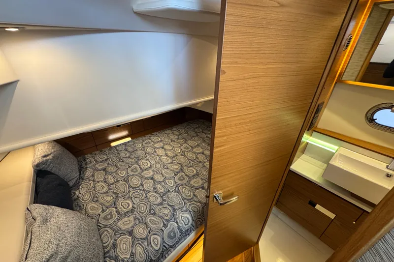 Slide: The Image of Luxurious cabin interior of 2025 Tiara Yachts 38 LS with modern design and cozy bedding. - 18