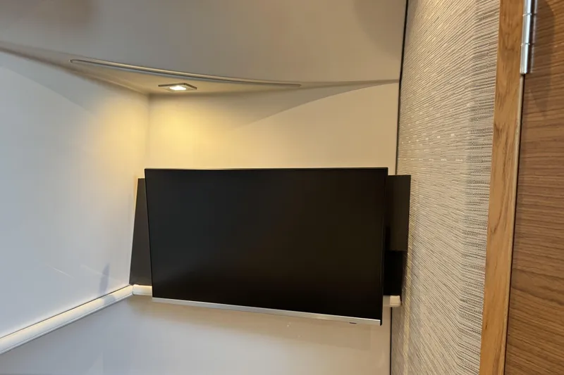 Slide: The Image of Modern interior of 2025 Tiara Yachts 38 LS with wall-mounted TV. - 19