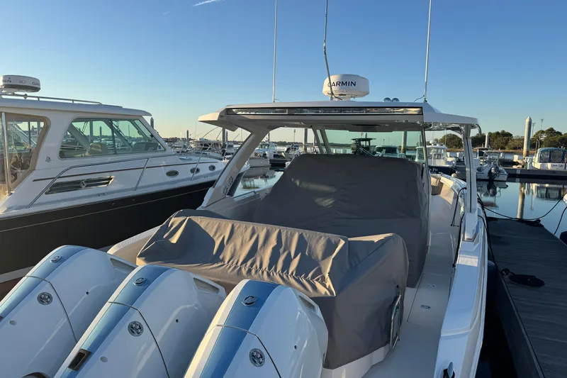 Slide: The Image of 2025 Tiara Yachts 38 LS docked, featuring sleek design and powerful engines. - 2