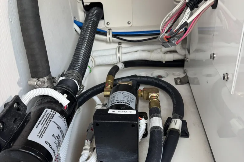 Slide: The Image of Engine compartment of 2025 Tiara Yachts 38 LS, showcasing hoses and wiring. - 28