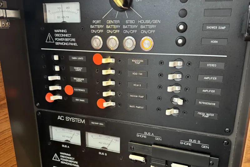Slide: The Image of Control panel of a 2025 Tiara Yachts 38 LS, featuring various switches and gauges. - 30