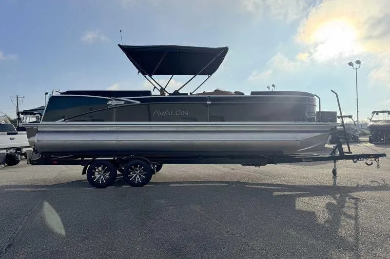 Slide: The Image of 2026 Avalon 2585 25 Catalina ENT pontoon boat on trailer under sunny sky. - 10